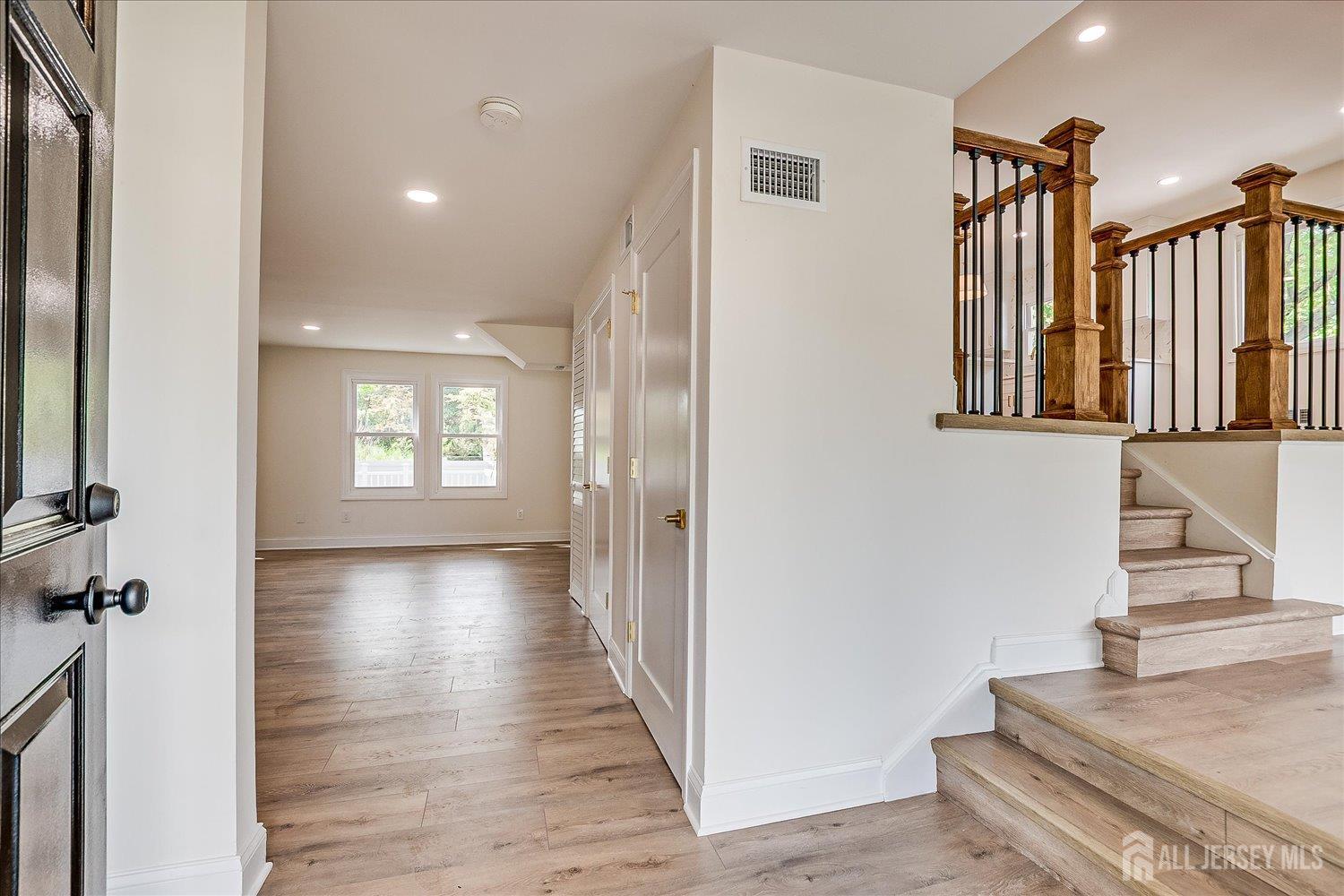 21 Lydia Lane Edison, NJ 08817 - Photo 13 of 49 a view of a hallway with wooden floor and staircase