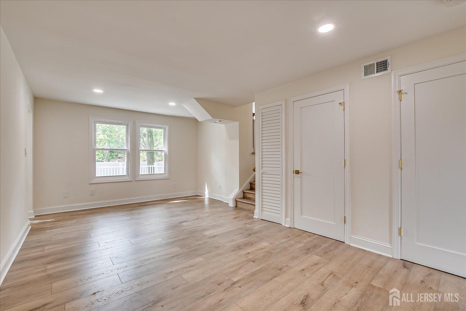 21 Lydia Lane Edison, NJ 08817 - Photo 14 of 49 a view of an empty room with wooden floor and a window