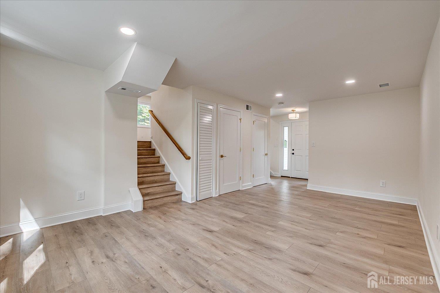 21 Lydia Lane Edison, NJ 08817 - Photo 16 of 49 a view of an empty room with wooden floor and stairs