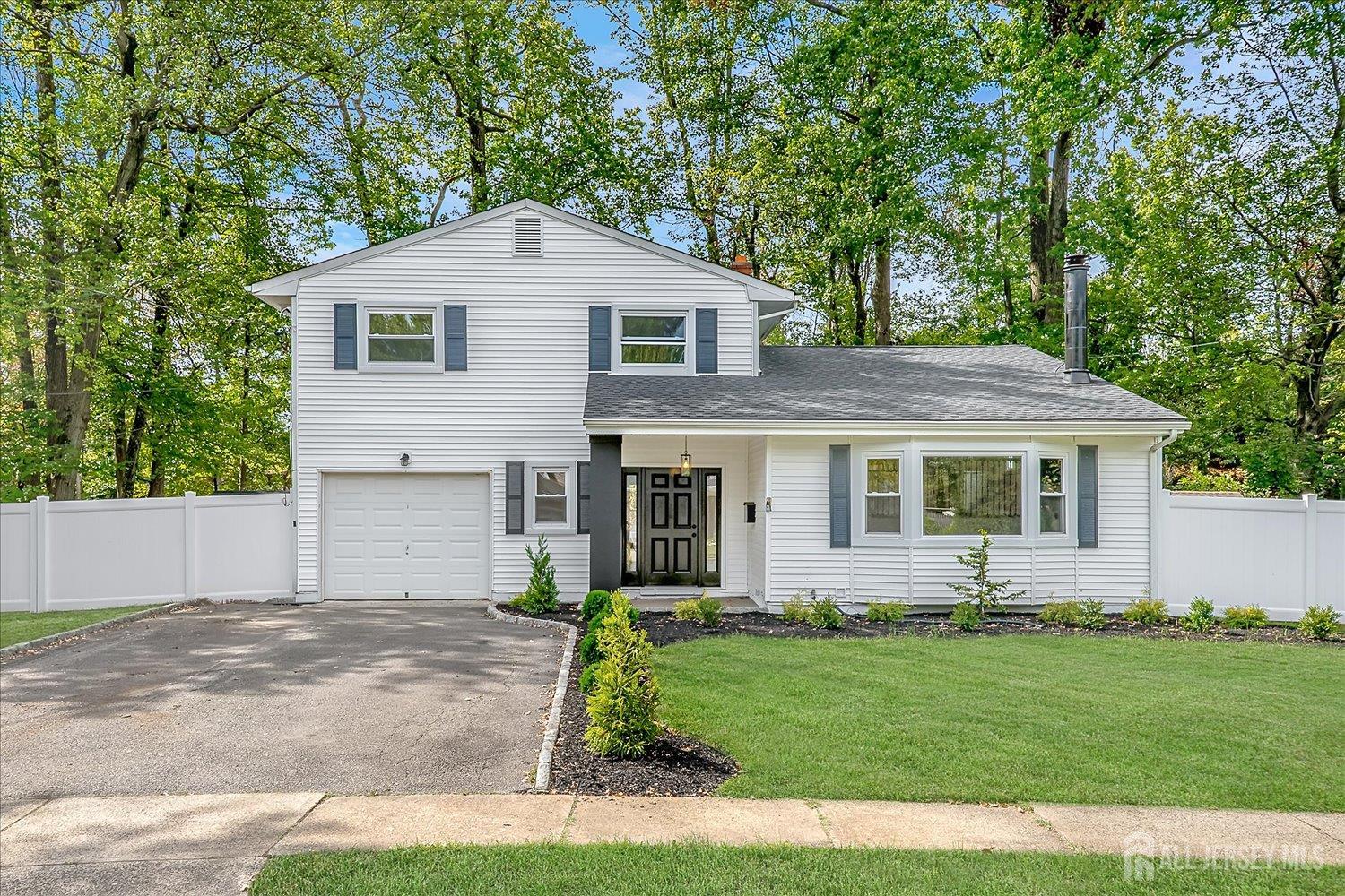 21 Lydia Lane Edison, NJ 08817 - Photo 2 of 49 a front view of a house with a garden and yard
