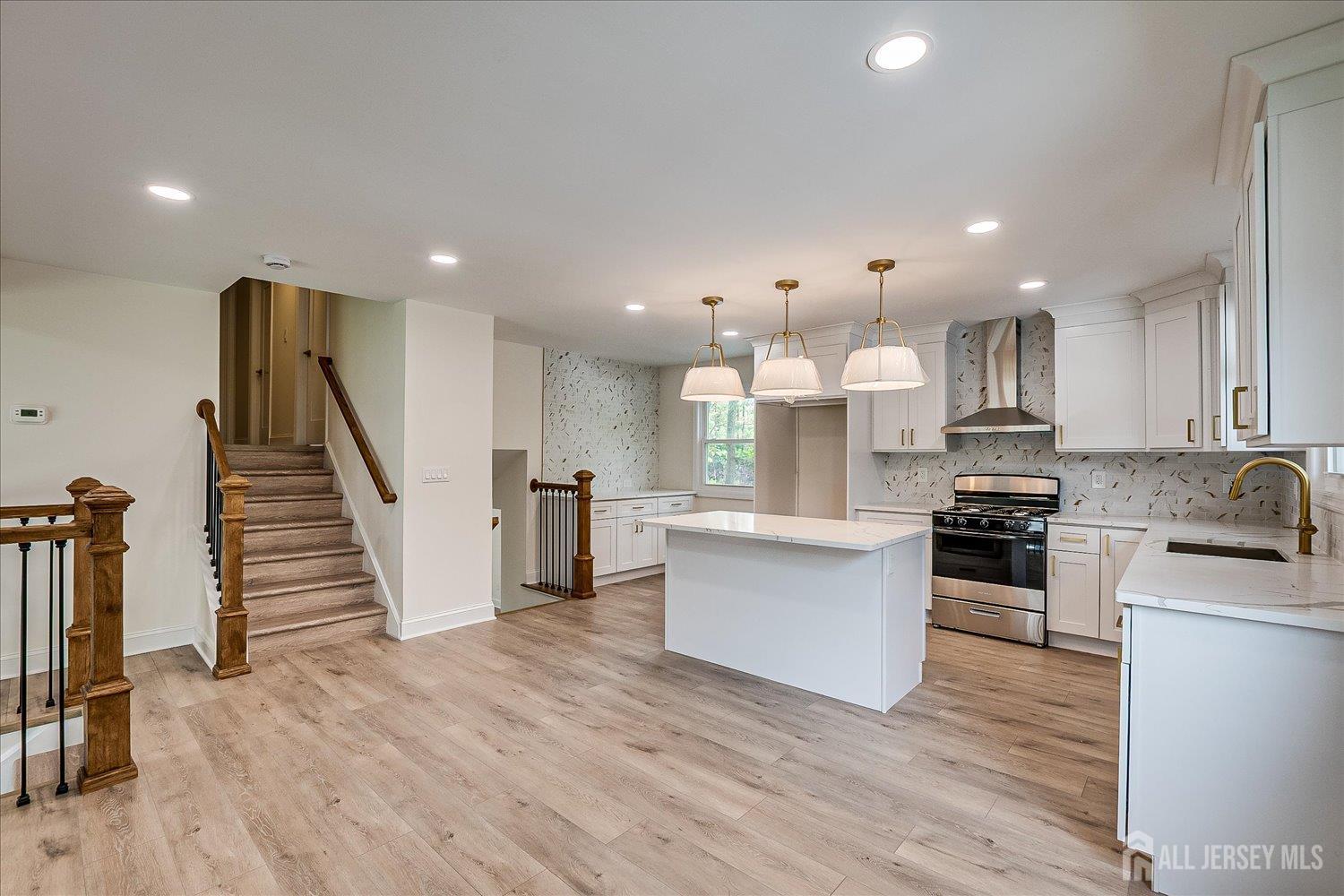 21 Lydia Lane Edison, NJ 08817 - Photo 21 of 49 a open kitchen with white cabinets stainless steel appliances and wooden floor