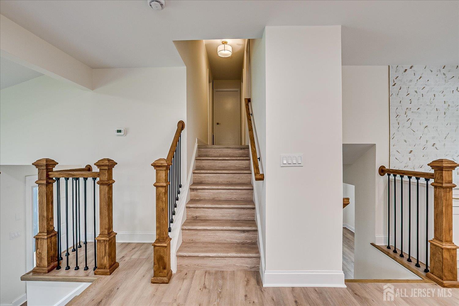21 Lydia Lane Edison, NJ 08817 - Photo 30 of 49 a view of a hallway with wooden floor and stairs