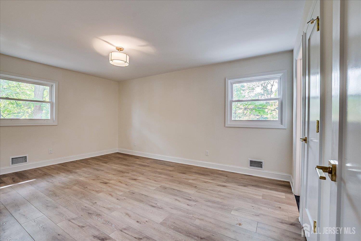 21 Lydia Lane Edison, NJ 08817 - Photo 31 of 49 a view of an empty room with wooden floor and a window