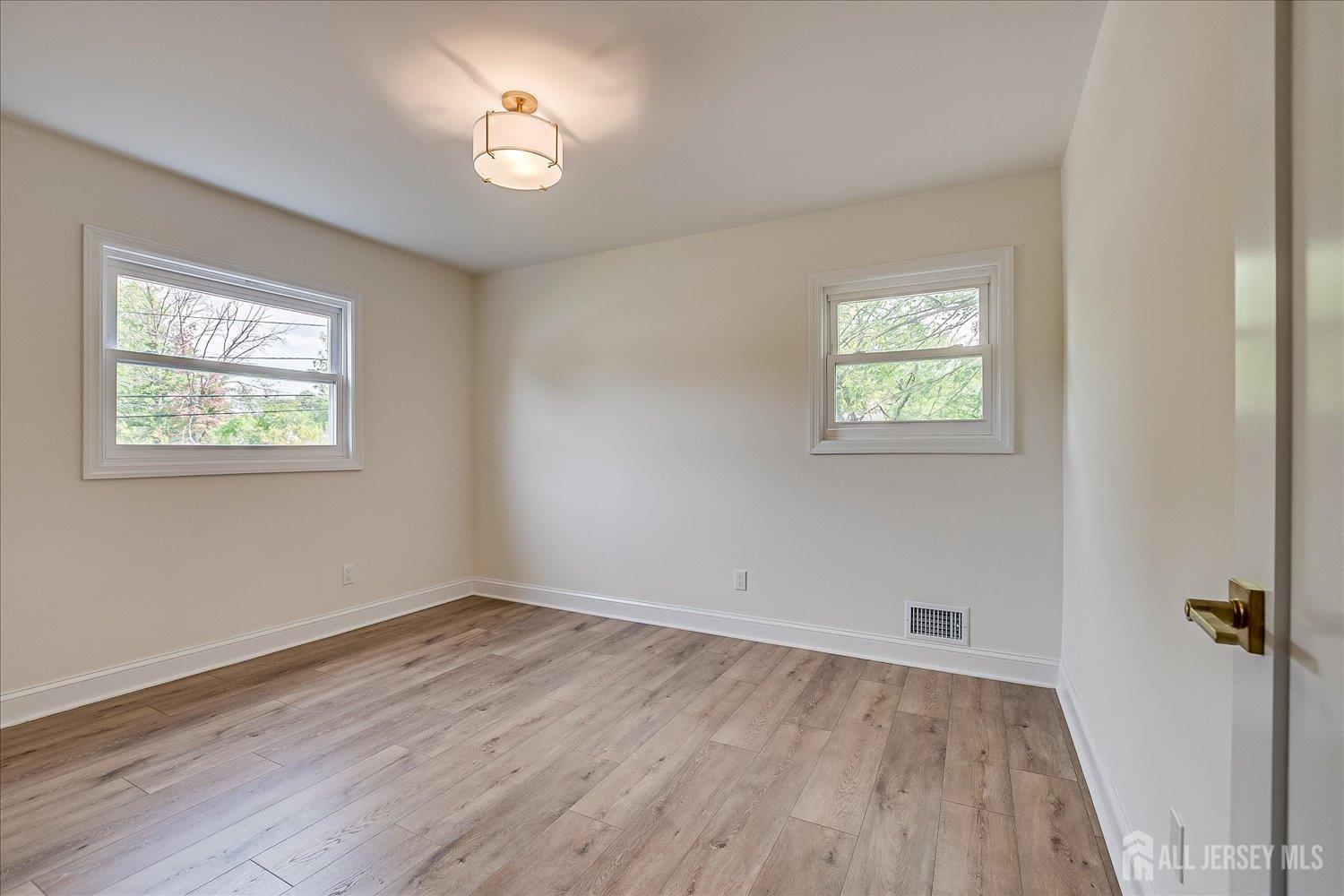 21 Lydia Lane Edison, NJ 08817 - Photo 34 of 49 a view of empty room with wooden floor and fan