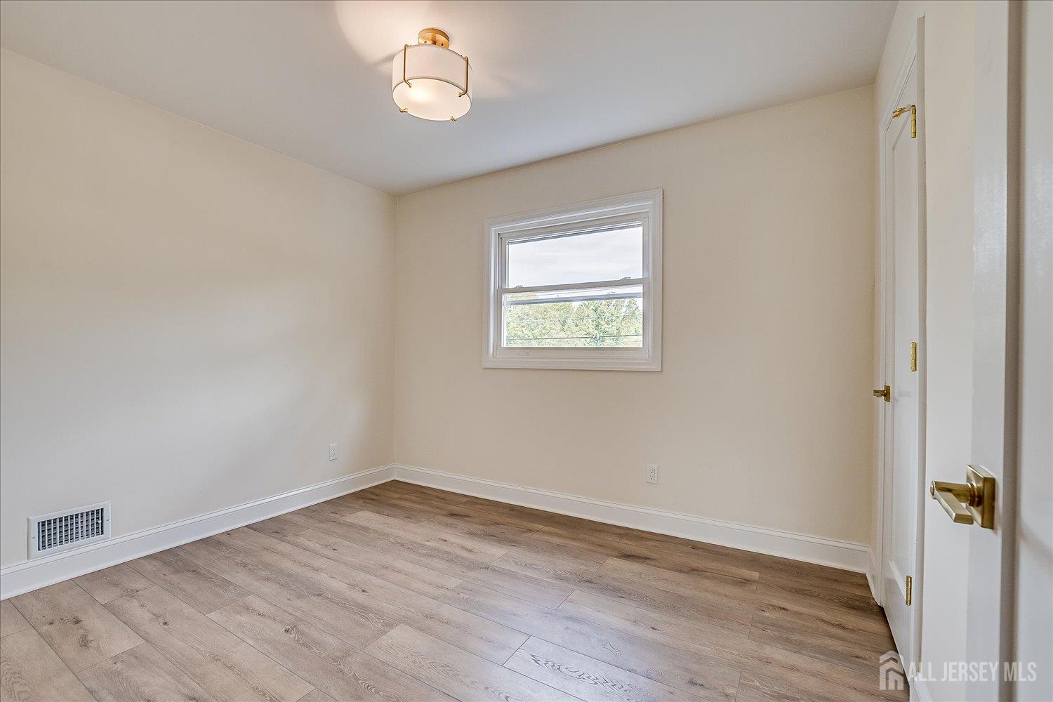 21 Lydia Lane Edison, NJ 08817 - Photo 36 of 49 an empty room with wooden floor and windows