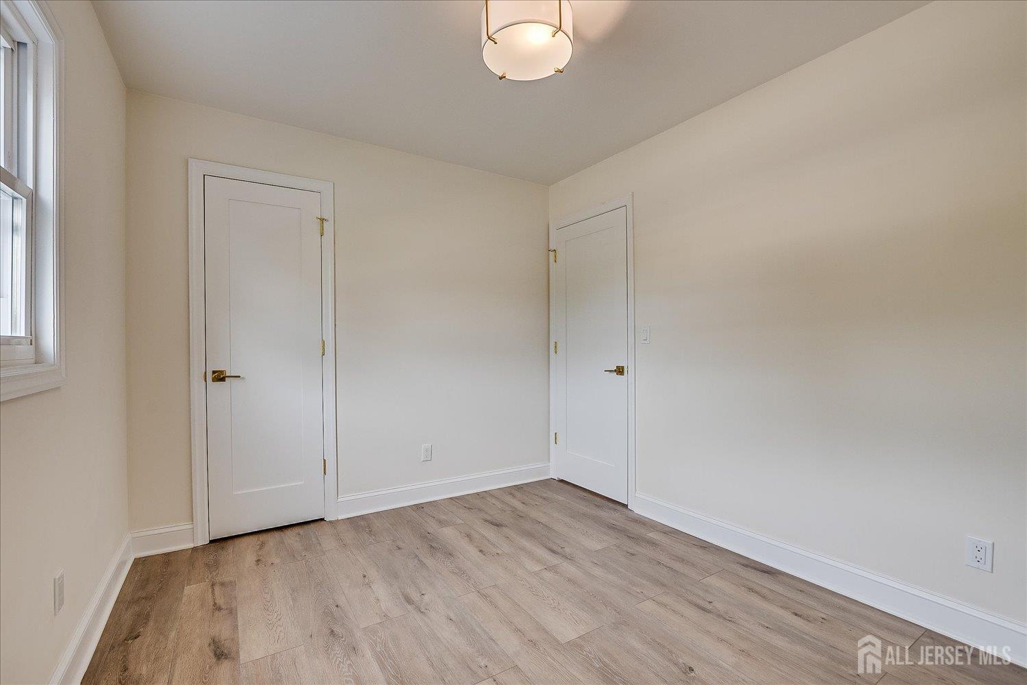 21 Lydia Lane Edison, NJ 08817 - Photo 37 of 49 a view of an empty room and wooden floor
