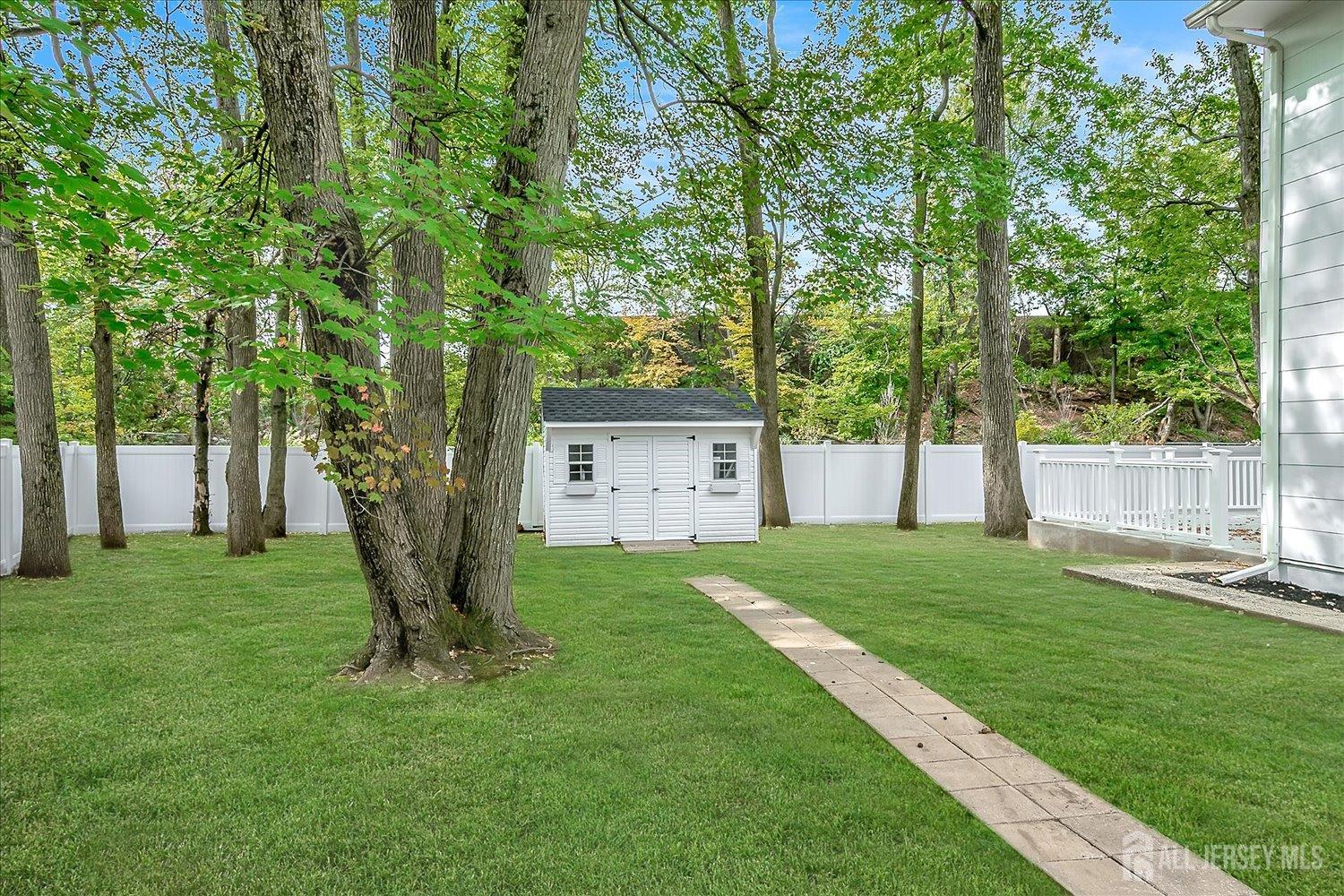21 Lydia Lane Edison, NJ 08817 - Photo 45 of 49 a view of a house with a yard and a large tree