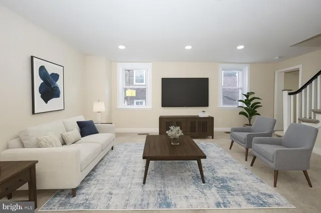 a living room with furniture and a flat screen tv