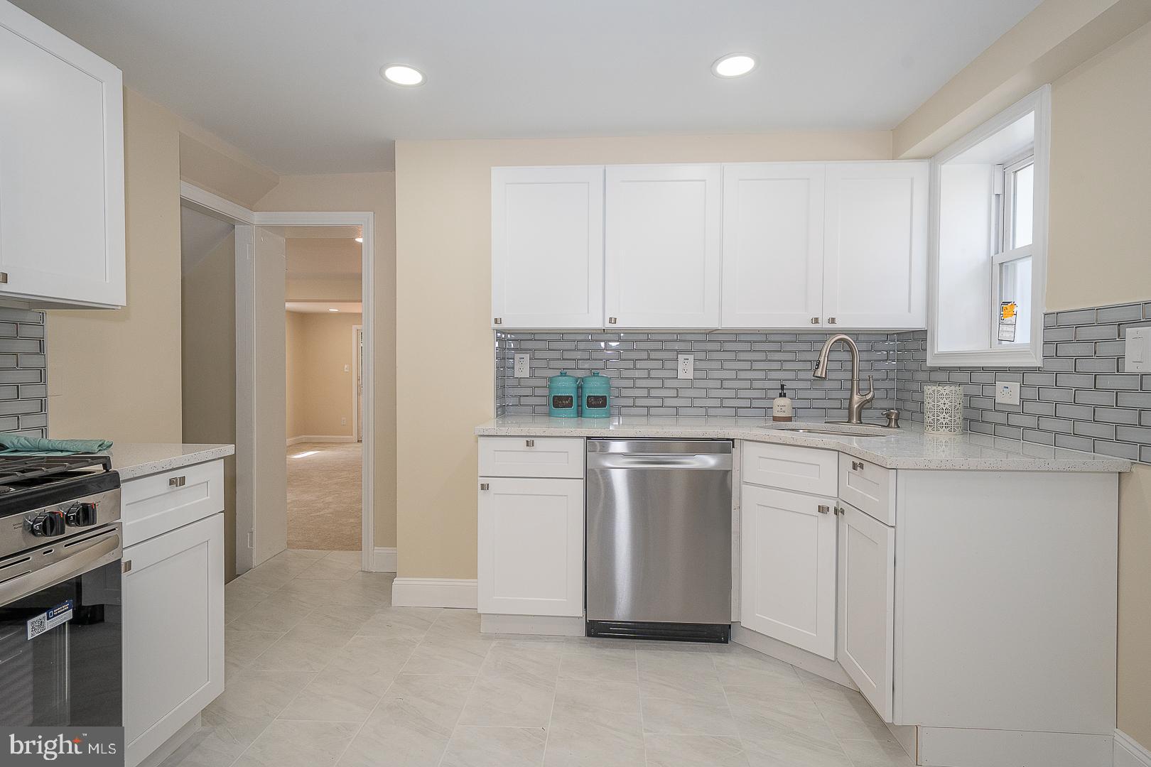 632 Merion Avenue Upper Darby, PA 19082 - Photo 29 of 84 a kitchen with white cabinets and white appliances