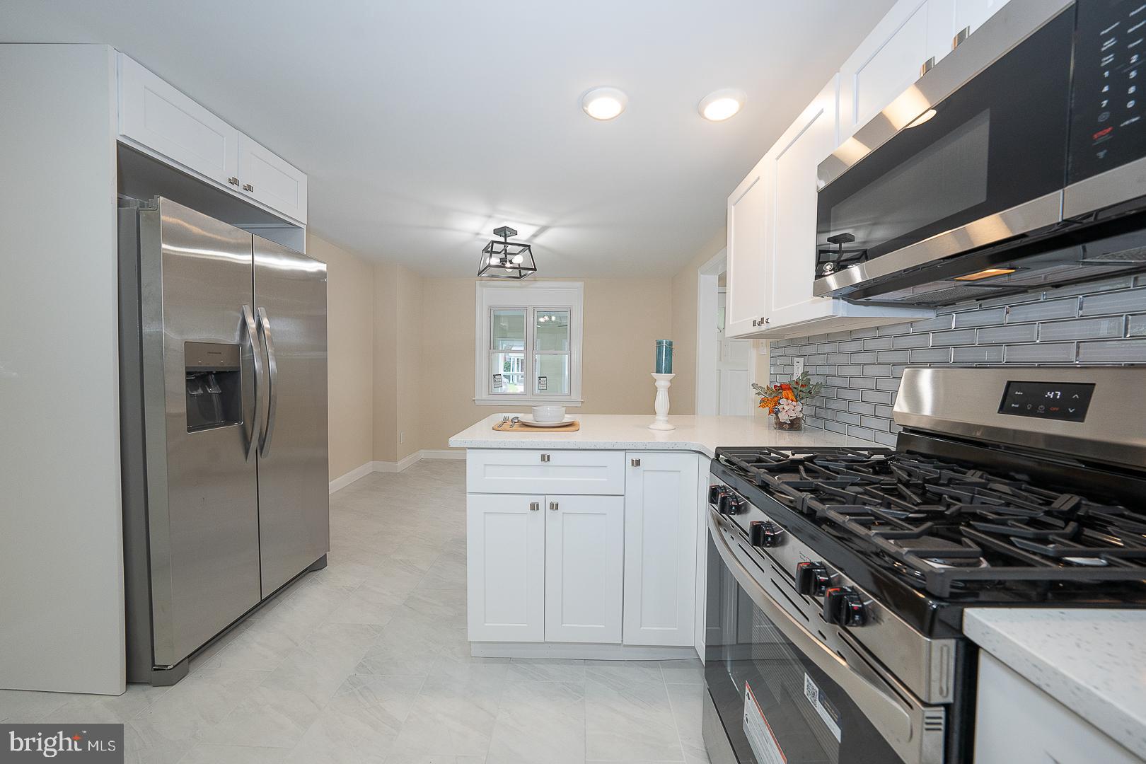 632 Merion Avenue Upper Darby, PA 19082 - Photo 32 of 84 a kitchen with stainless steel appliances granite countertop a stove and a refrigerator