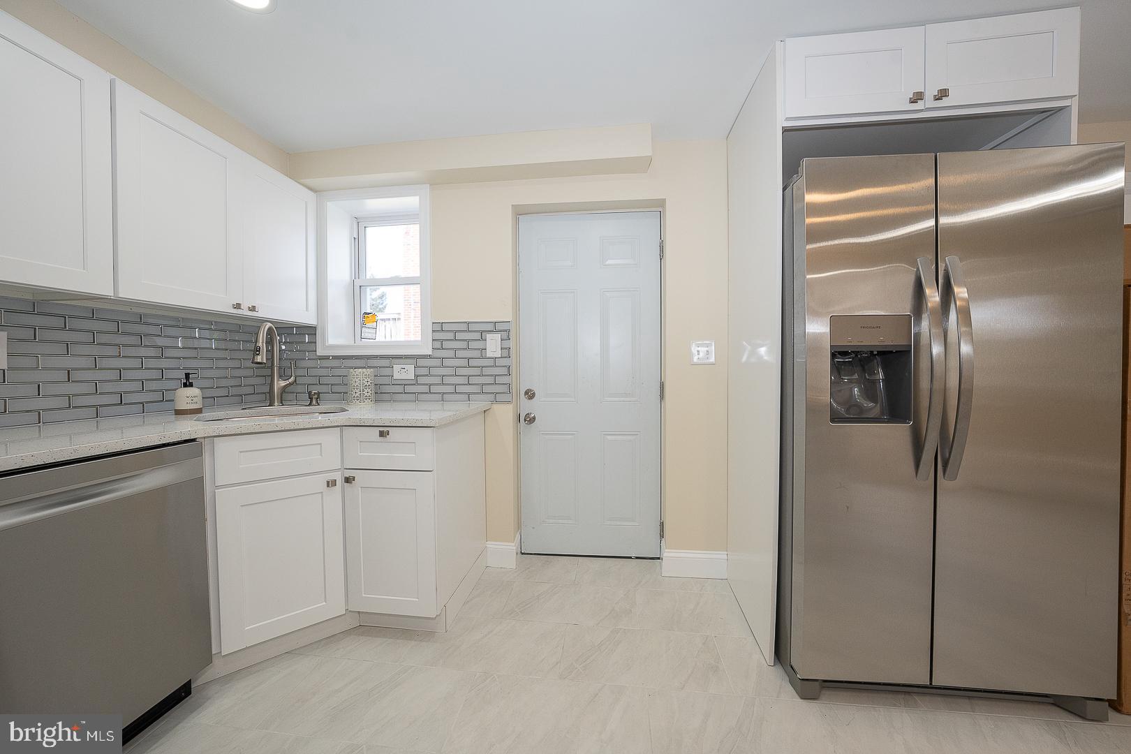 632 Merion Avenue Upper Darby, PA 19082 - Photo 34 of 84 a kitchen with a refrigerator and cabinets