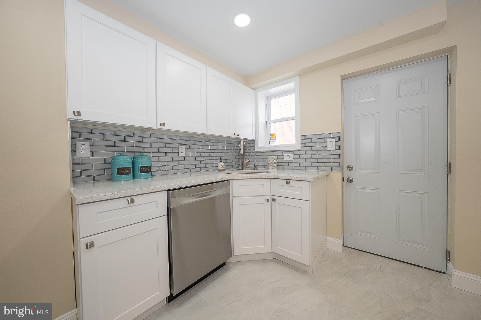 632 Merion Avenue Upper Darby, PA 19082 - Photo 35 of 84 a kitchen with white cabinets and white appliances