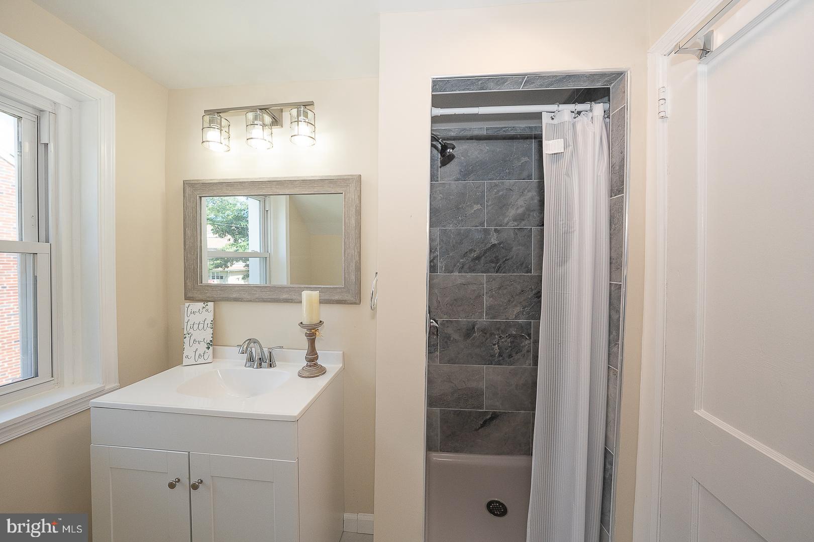 632 Merion Avenue Upper Darby, PA 19082 - Photo 48 of 84 a bathroom with a sink a vanity and a mirror
