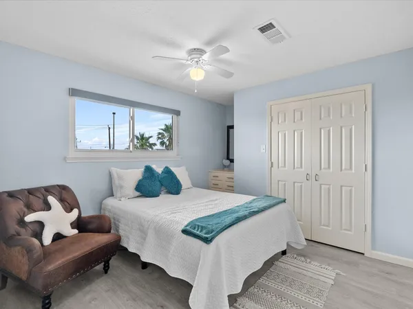 a bedroom with a bed and ceiling fan