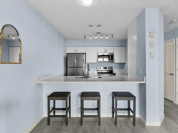 a kitchen with stainless steel appliances a sink and cabinets