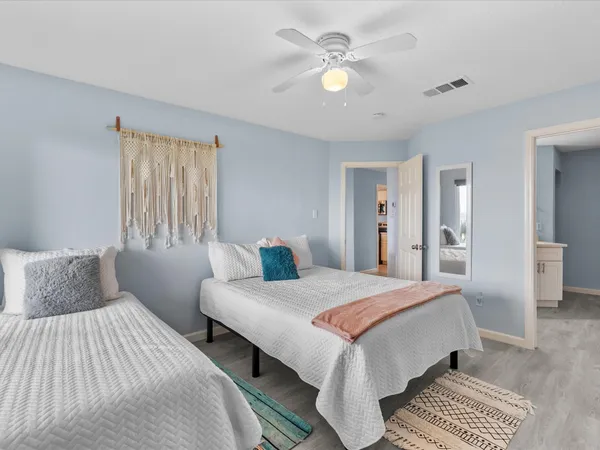 a bedroom with a bed and a chandelier