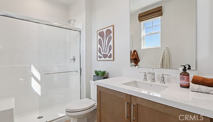 18318 Mystic Court Riverside, CA 92508 - Photo 12 of 47 a bathroom with a granite countertop sink a toilet a shower and a mirror
