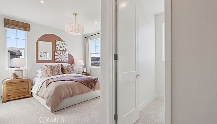 18318 Mystic Court Riverside, CA 92508 - Photo 21 of 47 a bedroom with a bed and a chandelier