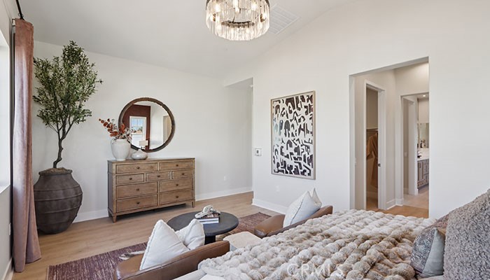 18318 Mystic Court Riverside, CA 92508 - Photo 22 of 47 a bedroom with a bed and a chandelier