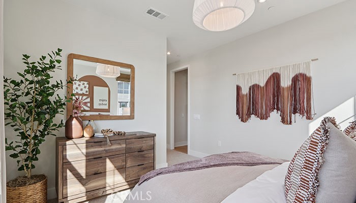 18318 Mystic Court Riverside, CA 92508 - Photo 30 of 47 a bedroom with a bed and dresser with mirror