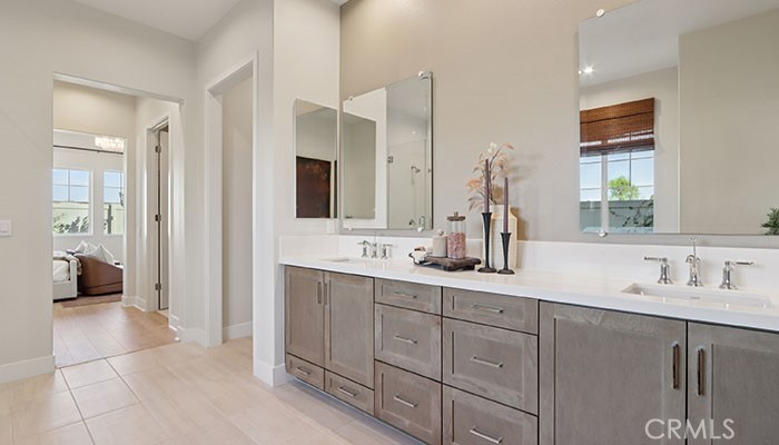 18318 Mystic Court Riverside, CA 92508 - Photo 3 of 47 a bathroom with a double vanity sink a mirror and a shower