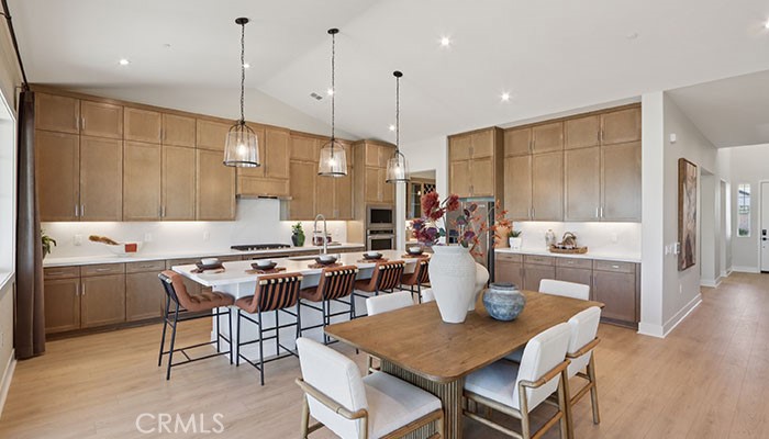 18318 Mystic Court Riverside, CA 92508 - Photo 40 of 47 a kitchen with a dining table chairs sink and stove