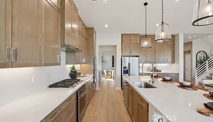 18318 Mystic Court Riverside, CA 92508 - Photo 43 of 47 a kitchen with a sink a stove and a refrigerator