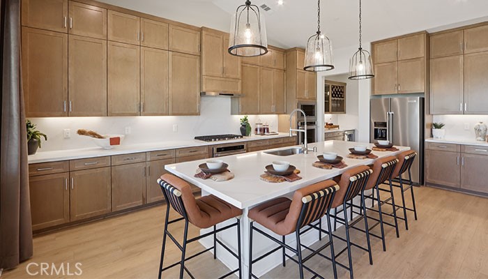 18318 Mystic Court Riverside, CA 92508 - Photo 44 of 47 a kitchen with a dining table cabinets appliances and a sink