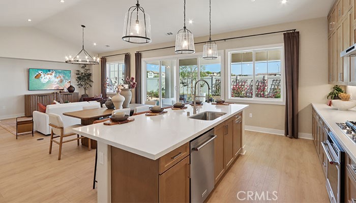 18318 Mystic Court Riverside, CA 92508 - Photo 46 of 47 a kitchen with kitchen island a sink dining table and chairs