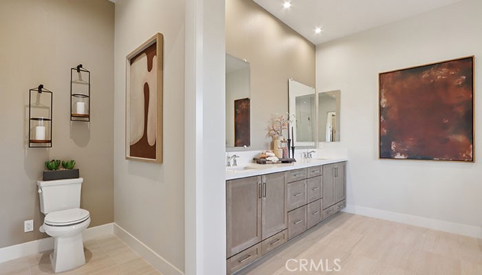 18318 Mystic Court Riverside, CA 92508 - Photo 6 of 47 a bathroom with a toilet a sink a mirror and a shower