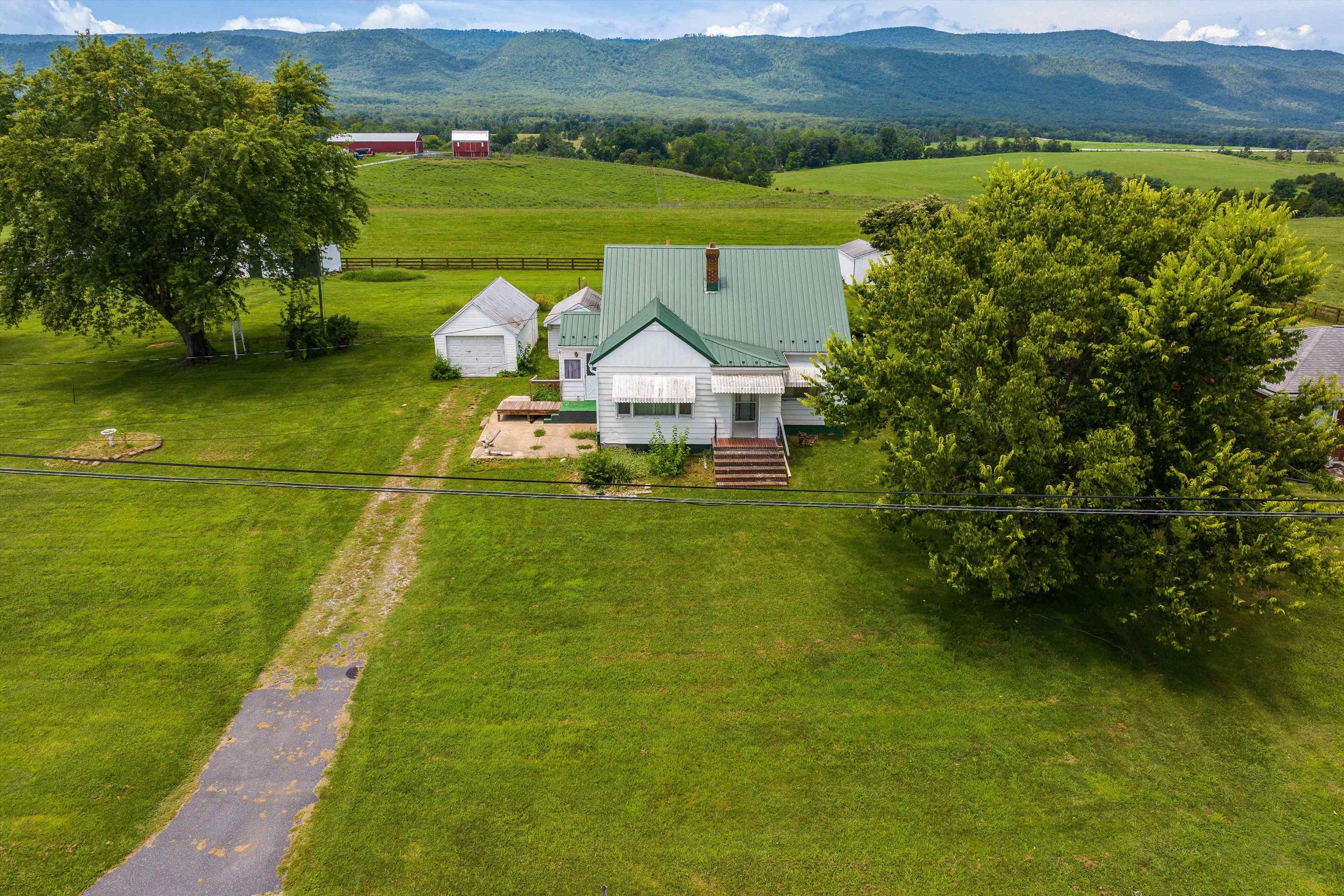 a aerial view of a house with a garden and lake view