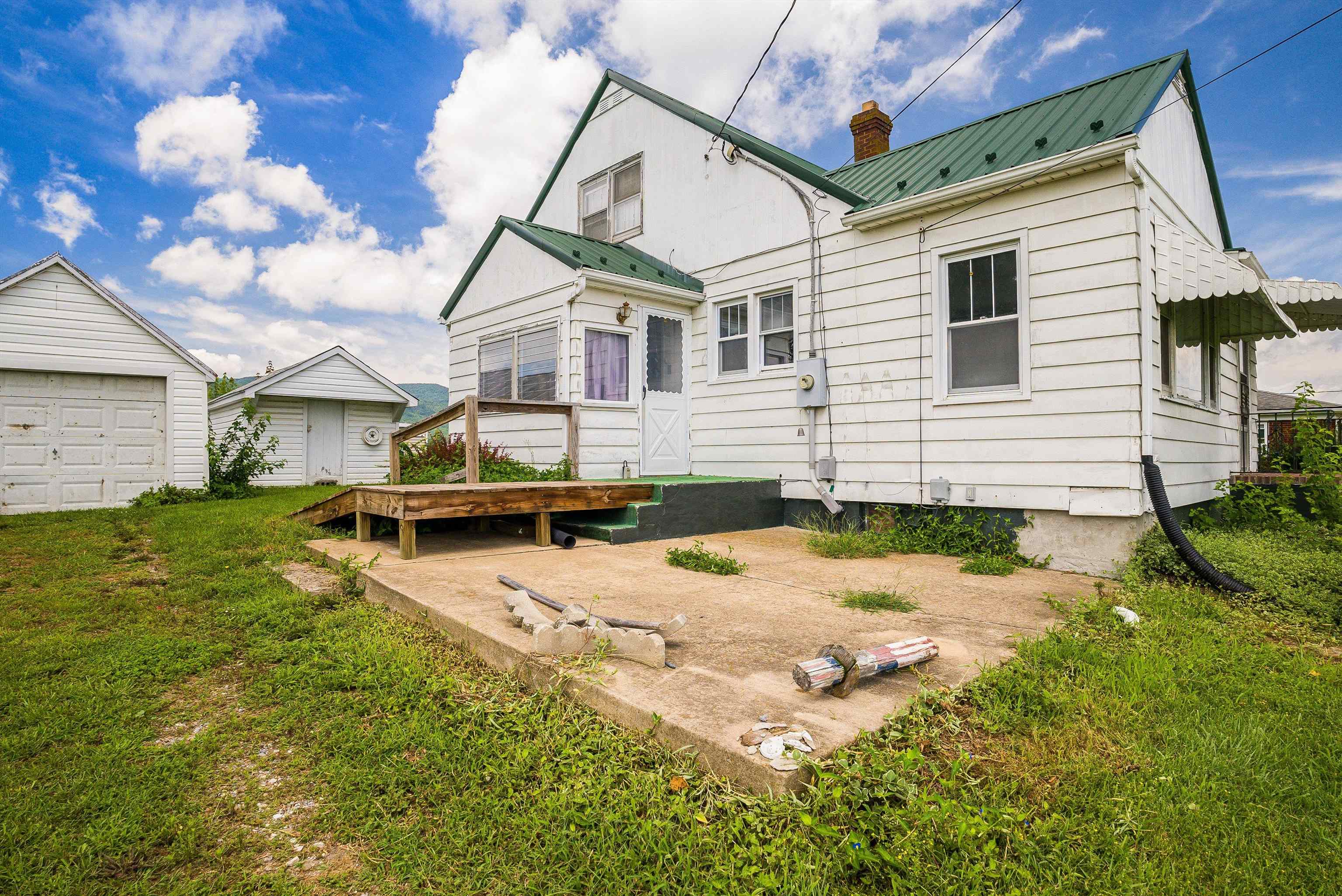 6507 East Point Road Elkton, VA 22827 - Photo 11 of 39 a view of a white house with a yard and sitting area