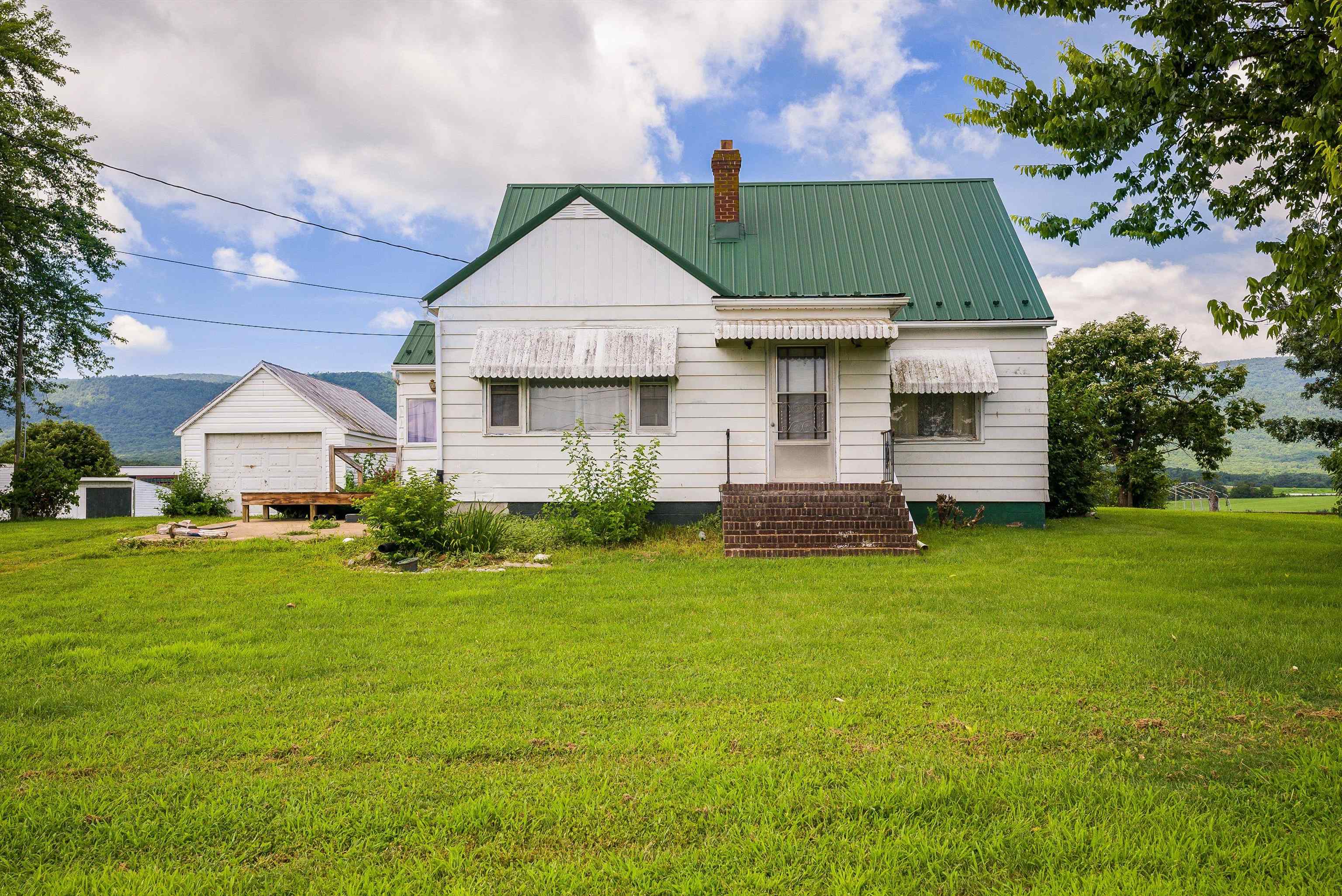 6507 East Point Road Elkton, VA 22827 - Photo 2 of 39 a front view of a house with a yard and trees