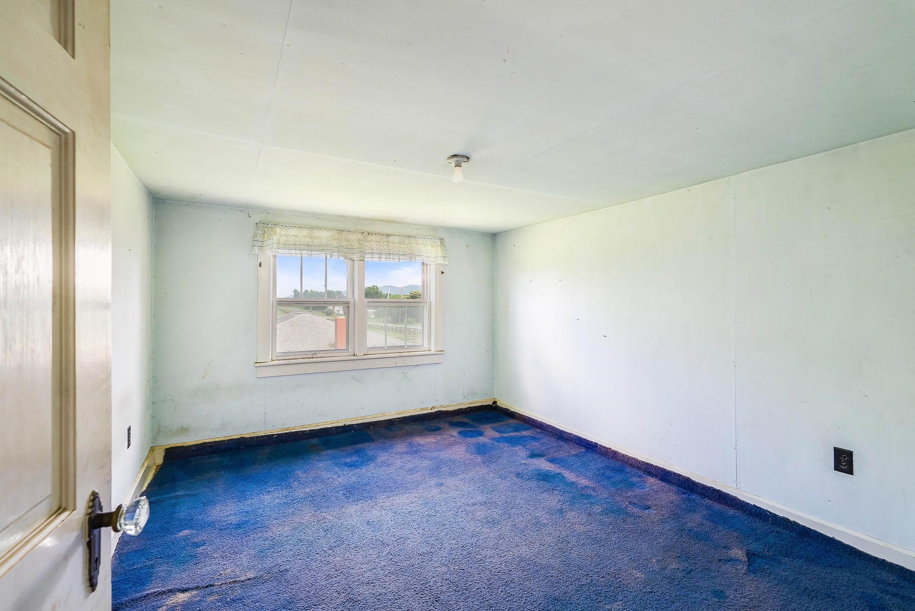 6507 East Point Road Elkton, VA 22827 - Photo 28 of 39 an empty room with wooden floor and windows