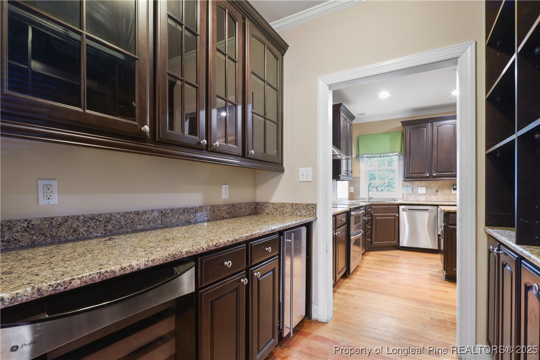 7124 Holmfield Road Fayetteville, NC 28306 - Photo 11 of 45 a kitchen with stainless steel appliances granite countertop a sink and stove top oven