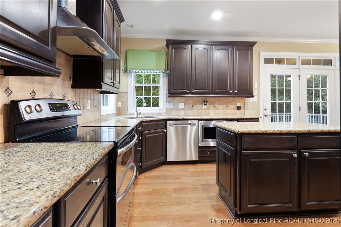7124 Holmfield Road Fayetteville, NC 28306 - Photo 13 of 45 a kitchen with a stove sink and cabinets