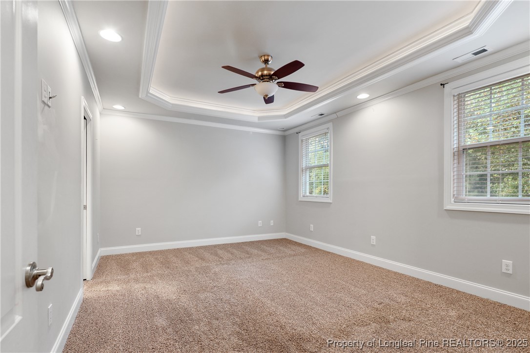 7124 Holmfield Road Fayetteville, NC 28306 - Photo 26 of 45 an empty room with windows and ceiling fan