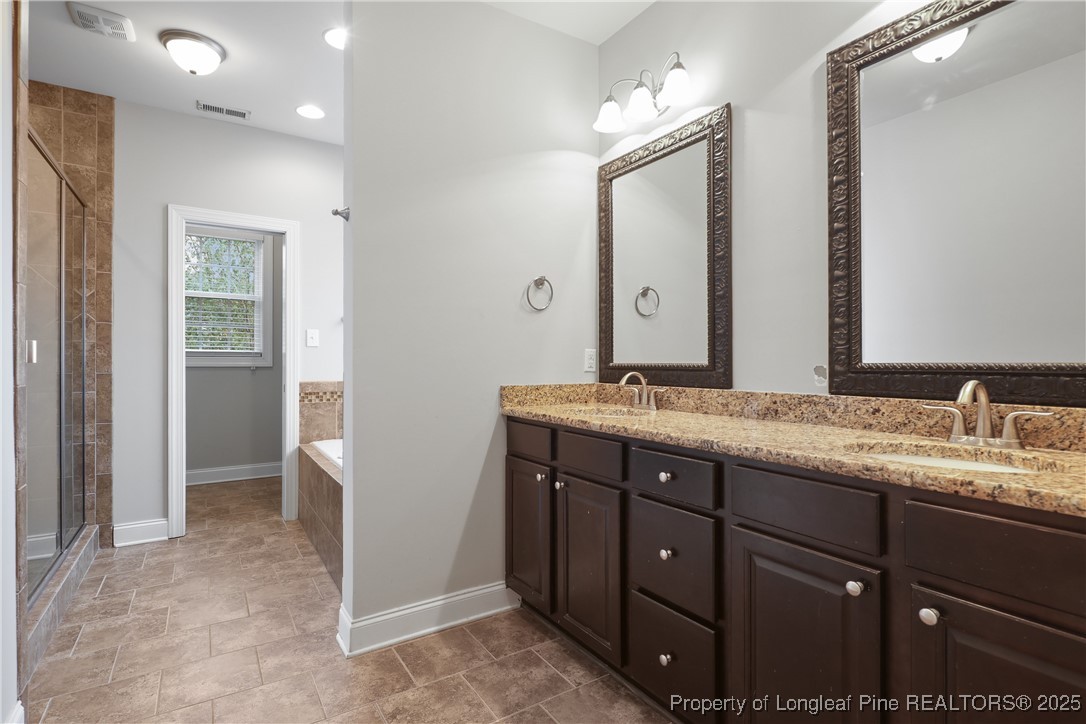 7124 Holmfield Road Fayetteville, NC 28306 - Photo 28 of 45 a bathroom with a granite countertop sink and a mirror
