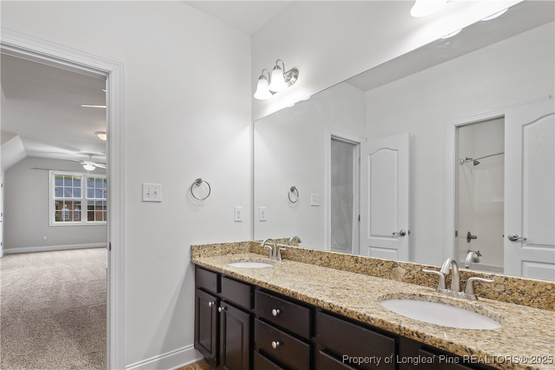 7124 Holmfield Road Fayetteville, NC 28306 - Photo 33 of 45 a bathroom with a granite countertop double vanity sink and a mirror