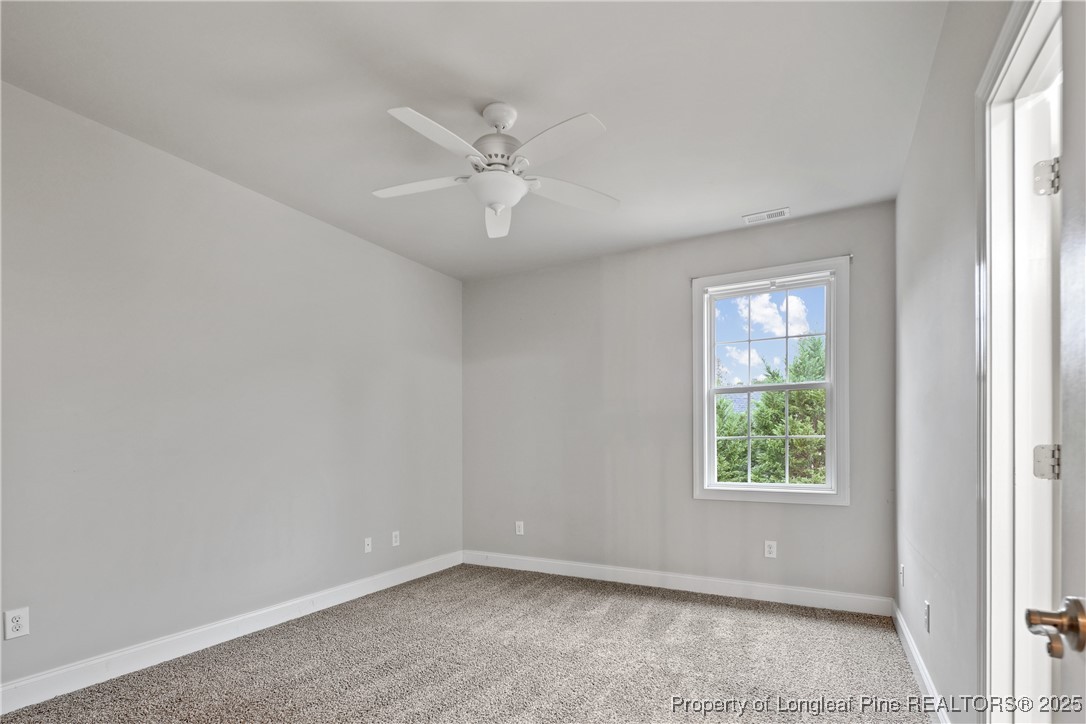 7124 Holmfield Road Fayetteville, NC 28306 - Photo 34 of 45 an empty room with windows and fan