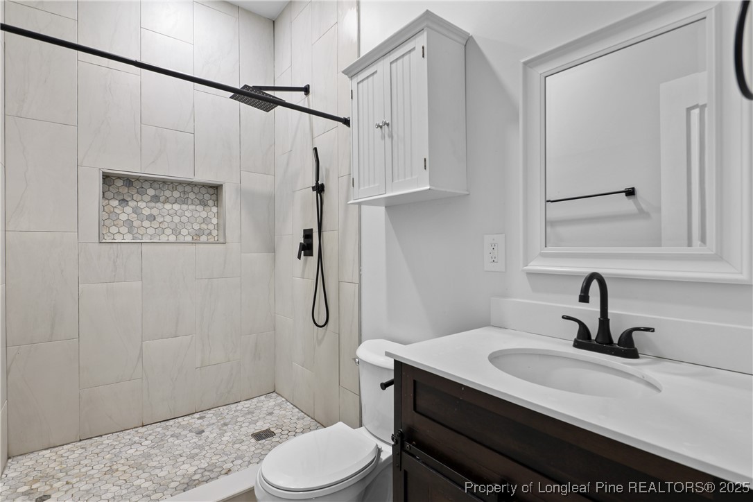 7124 Holmfield Road Fayetteville, NC 28306 - Photo 37 of 45 a bathroom with a sink toilet and shower