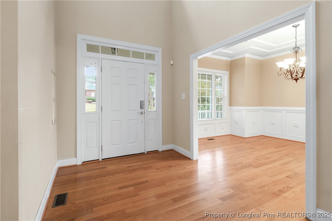 7124 Holmfield Road Fayetteville, NC 28306 - Photo 8 of 45 an empty room with wooden floor and windows
