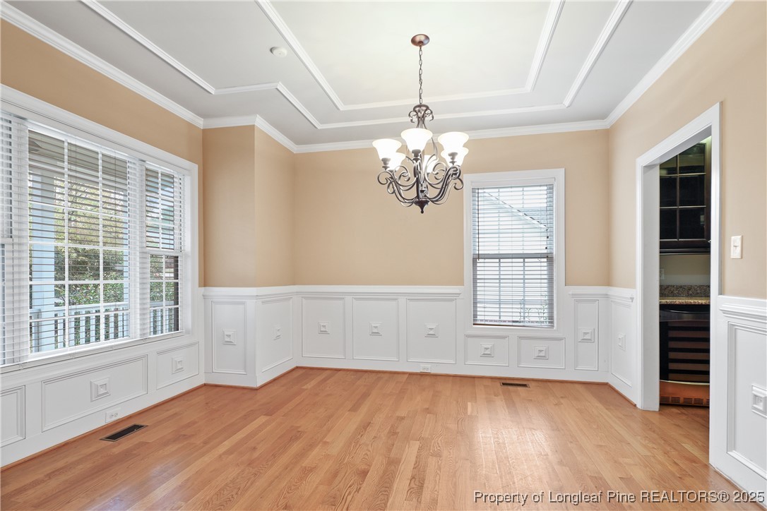 7124 Holmfield Road Fayetteville, NC 28306 - Photo 9 of 45 a view of empty room with wooden floor and fan