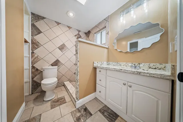 a bathroom with a sink toilet and shower