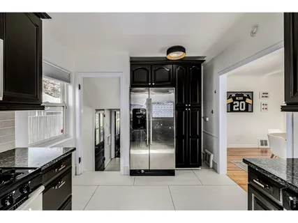 a kitchen with stainless steel appliances kitchen island a refrigerator and a stove