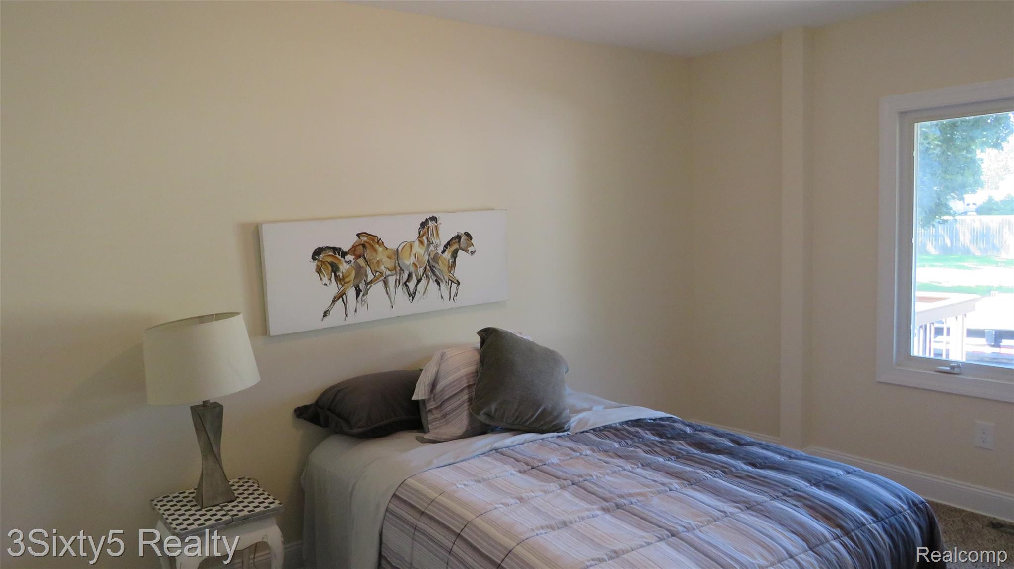 16558 Haggerty Road Belleville, MI 48111 - Photo 26 of 40 Spacious room featuring neutral painted walls, white trim, and a window with natural light