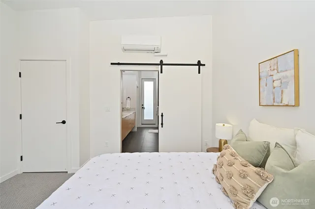 a bedroom with a bed and a painting on the wall