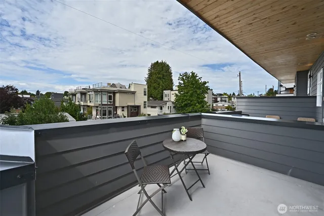 a view of a chairs and table in a balcony