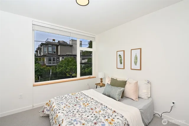 a bedroom with a bed and a large window