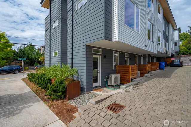 a view of a house with cars park